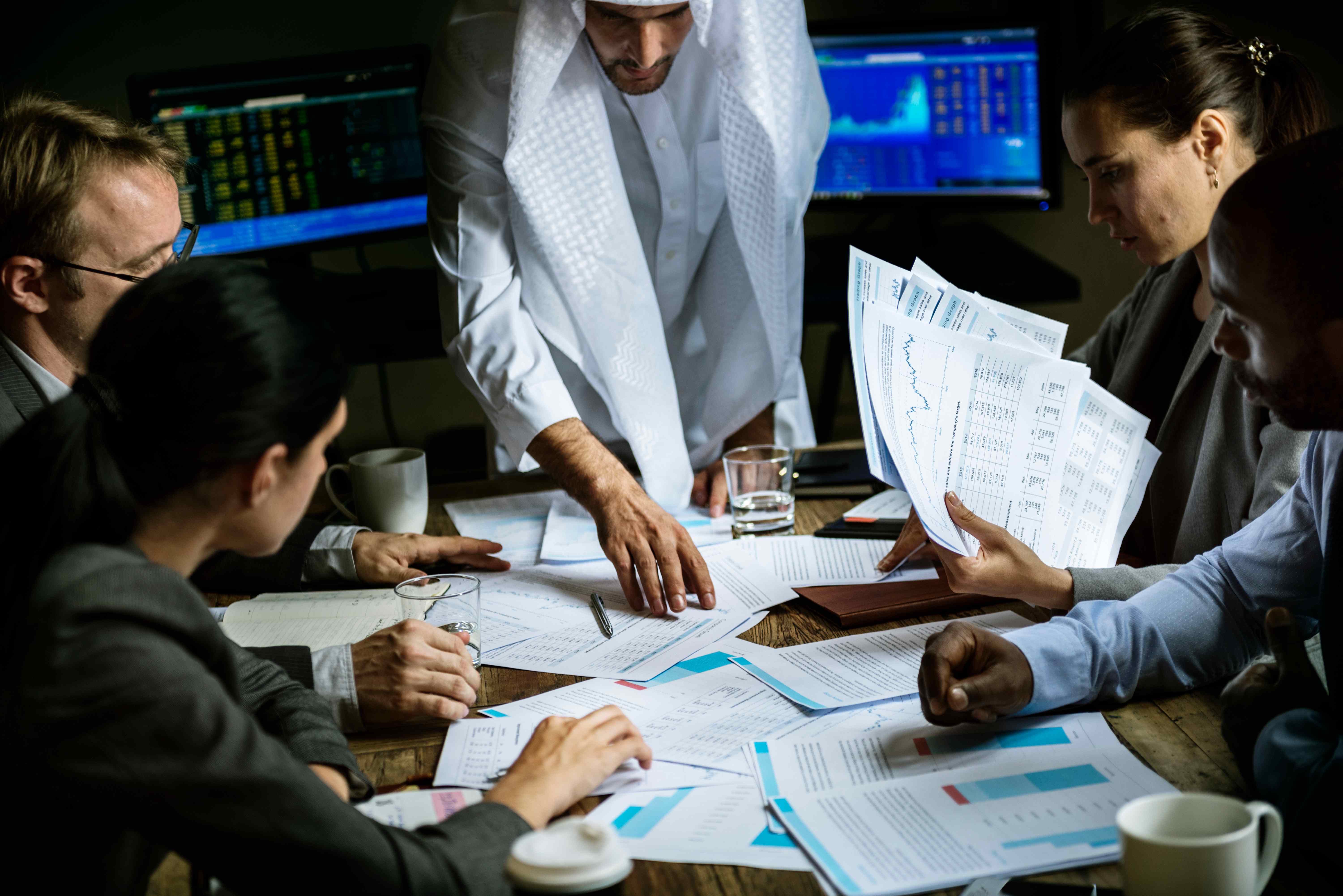 Business professionals reviewing documents and data in a meeting